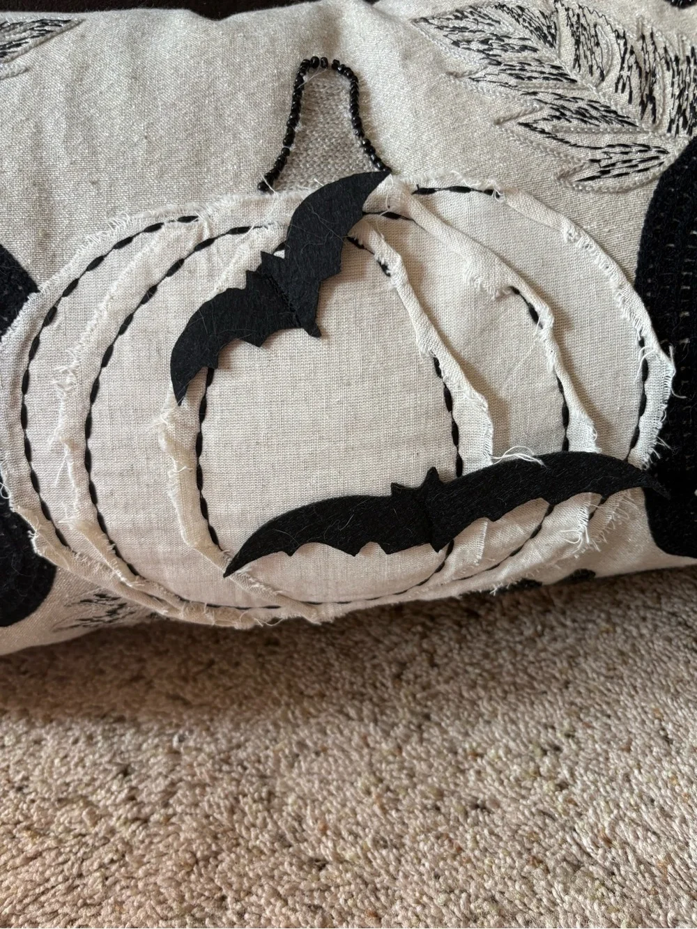 Appliquéd and sewn sparkle pumpkin pillow.